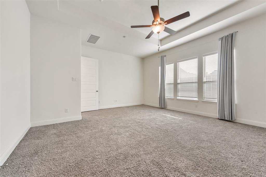 2714 Chambray Lane Mansfield, TX 76063 - Photo 25 of 32 an empty room with chandelier fan and windows
