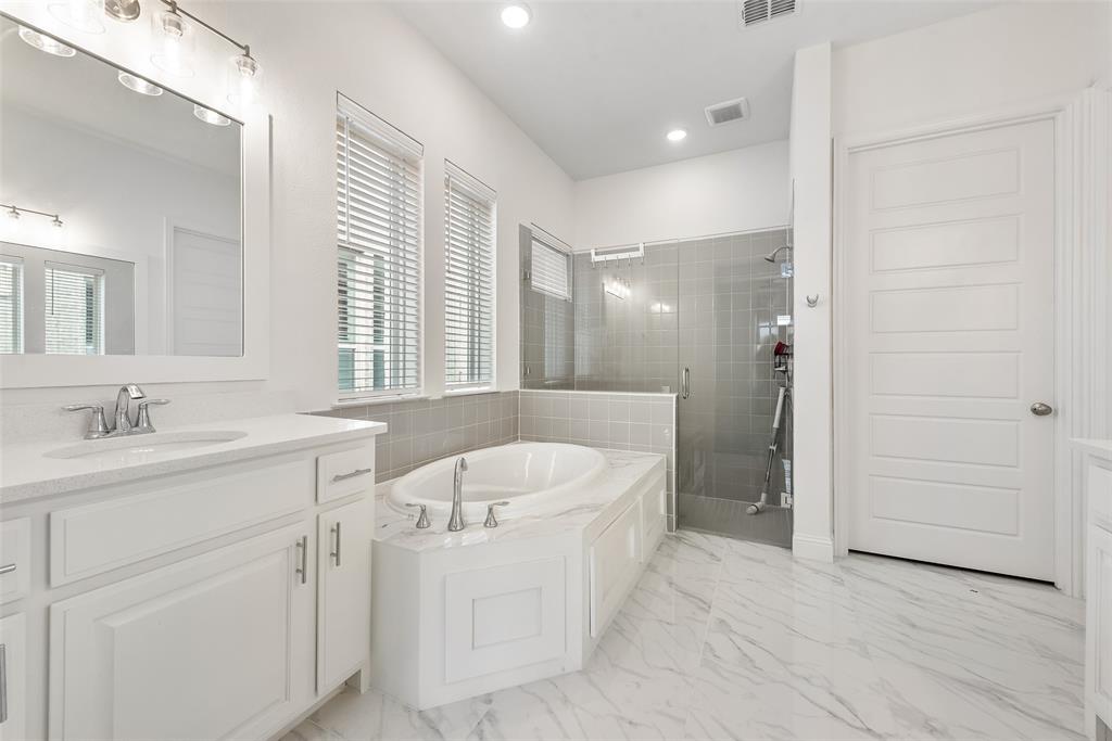 2714 Chambray Lane Mansfield, TX 76063 - Photo 27 of 32 a bathroom with a sink double vanity granite tub shower and a mirror