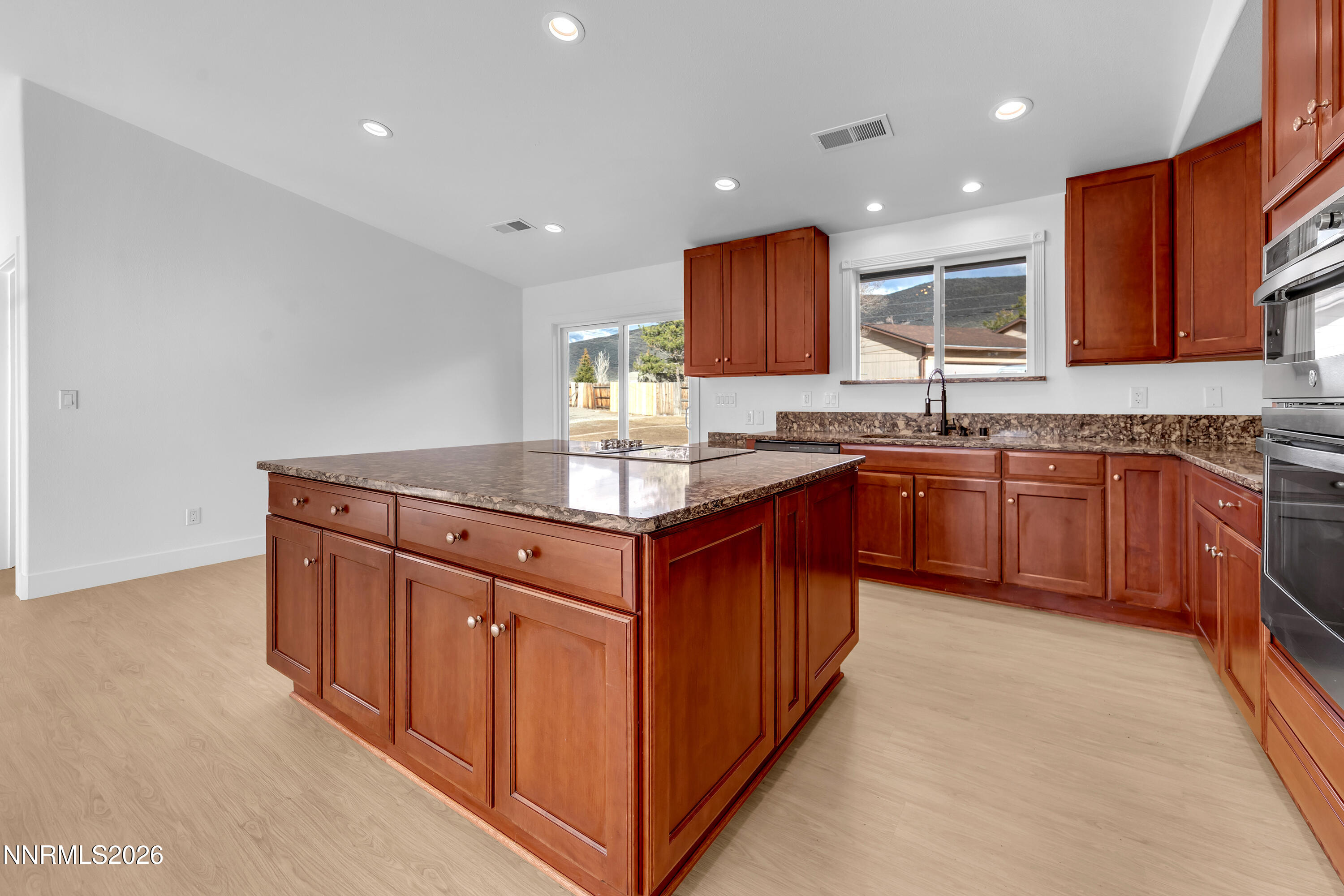 a kitchen with stainless steel appliances granite countertop wooden cabinets a sink and dishwasher