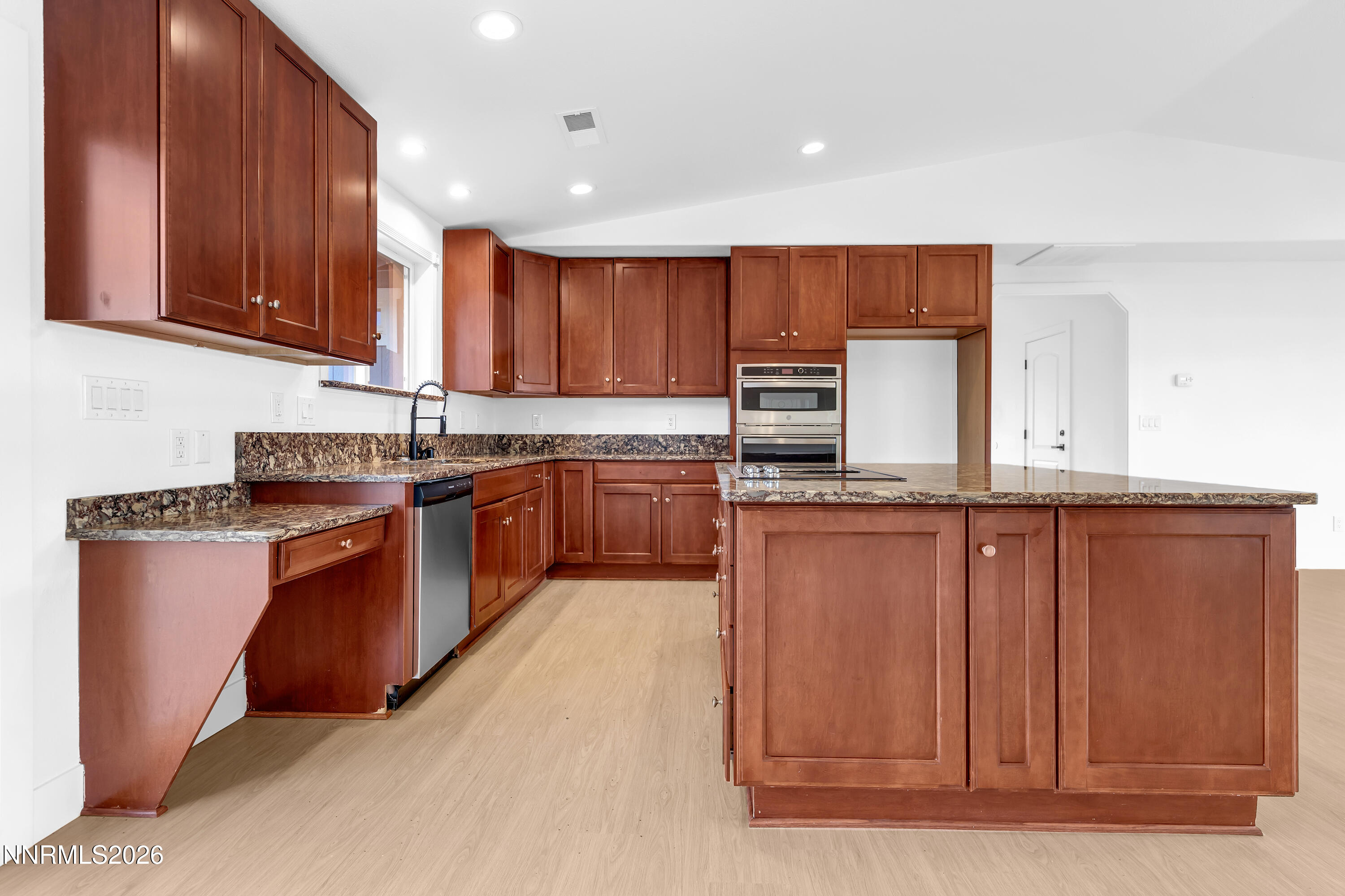 3825 Dyal Court Reno, NV 89508 - Photo 12 of 39 a kitchen with stainless steel appliances granite countertop wooden cabinets a sink and dishwasher