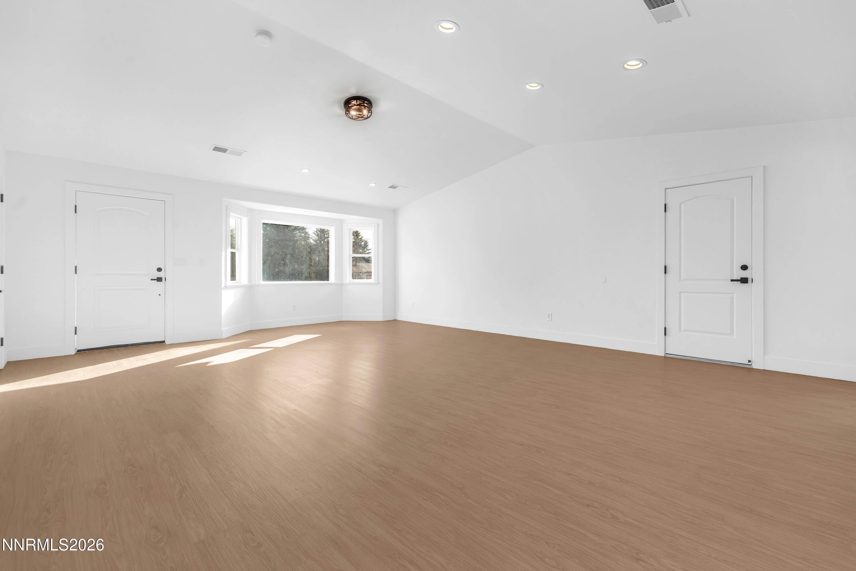 3825 Dyal Court Reno, NV 89508 - Photo 6 of 39 a view of an empty room with wooden floor and a window