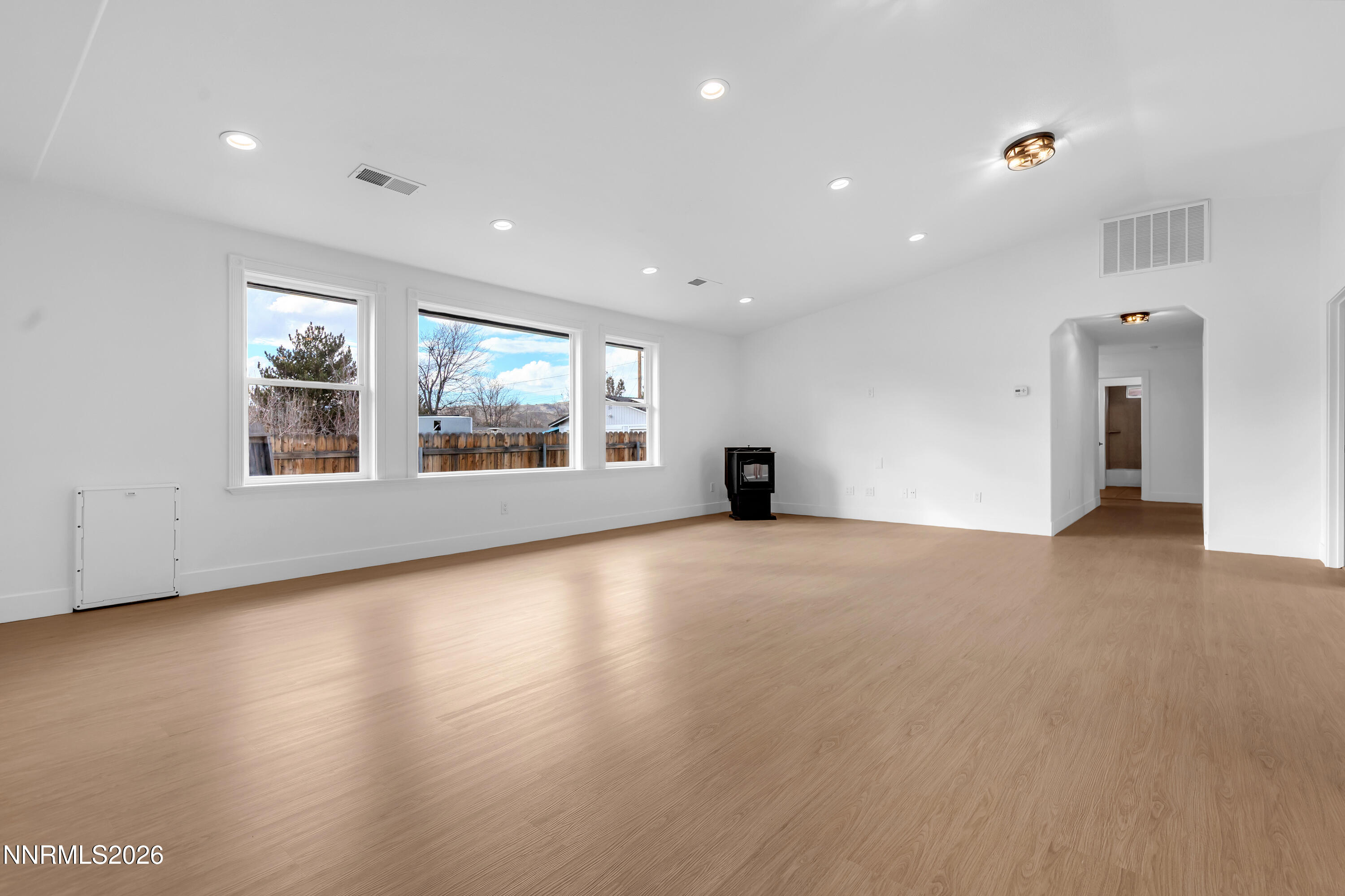 3825 Dyal Court Reno, NV 89508 - Photo 7 of 39 a view of an empty room with a window and wooden floor