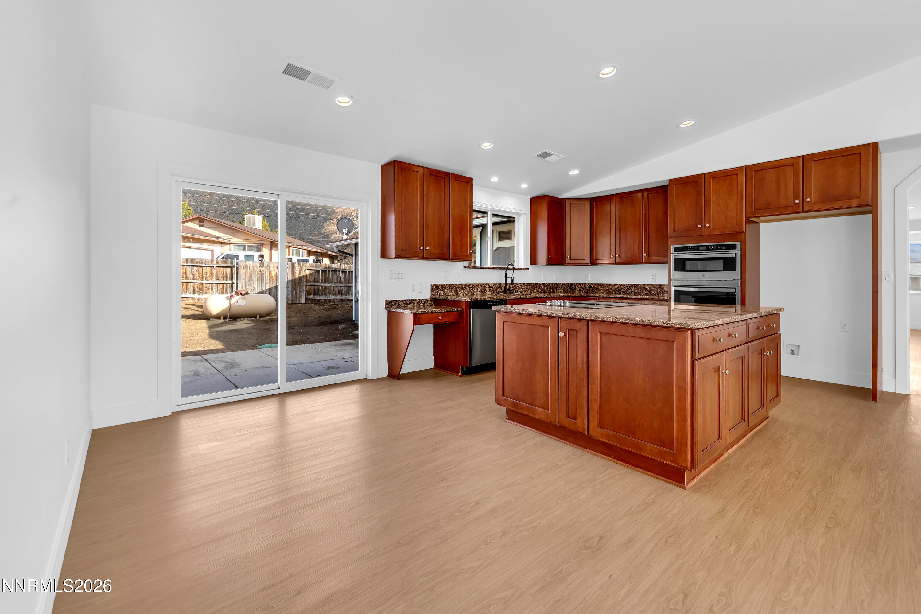 3825 Dyal Court Reno, NV 89508 - Photo 10 of 39 a kitchen with stainless steel appliances granite countertop a stove a sink and a refrigerator