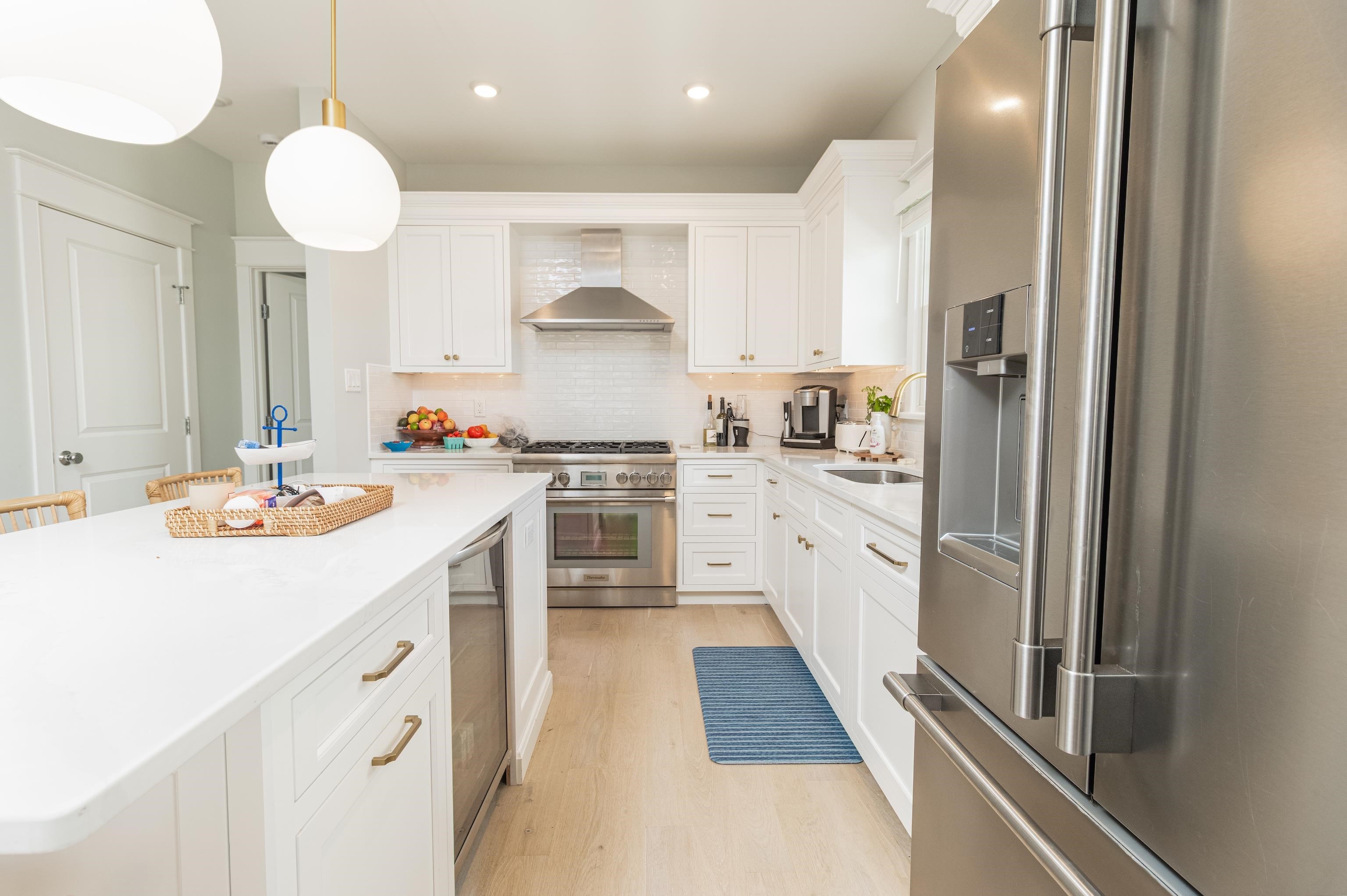 8 East 27th, Unit WEST Avalon, NJ 08202 - Photo 14 of 32 a kitchen with a sink stainless steel appliances and cabinets