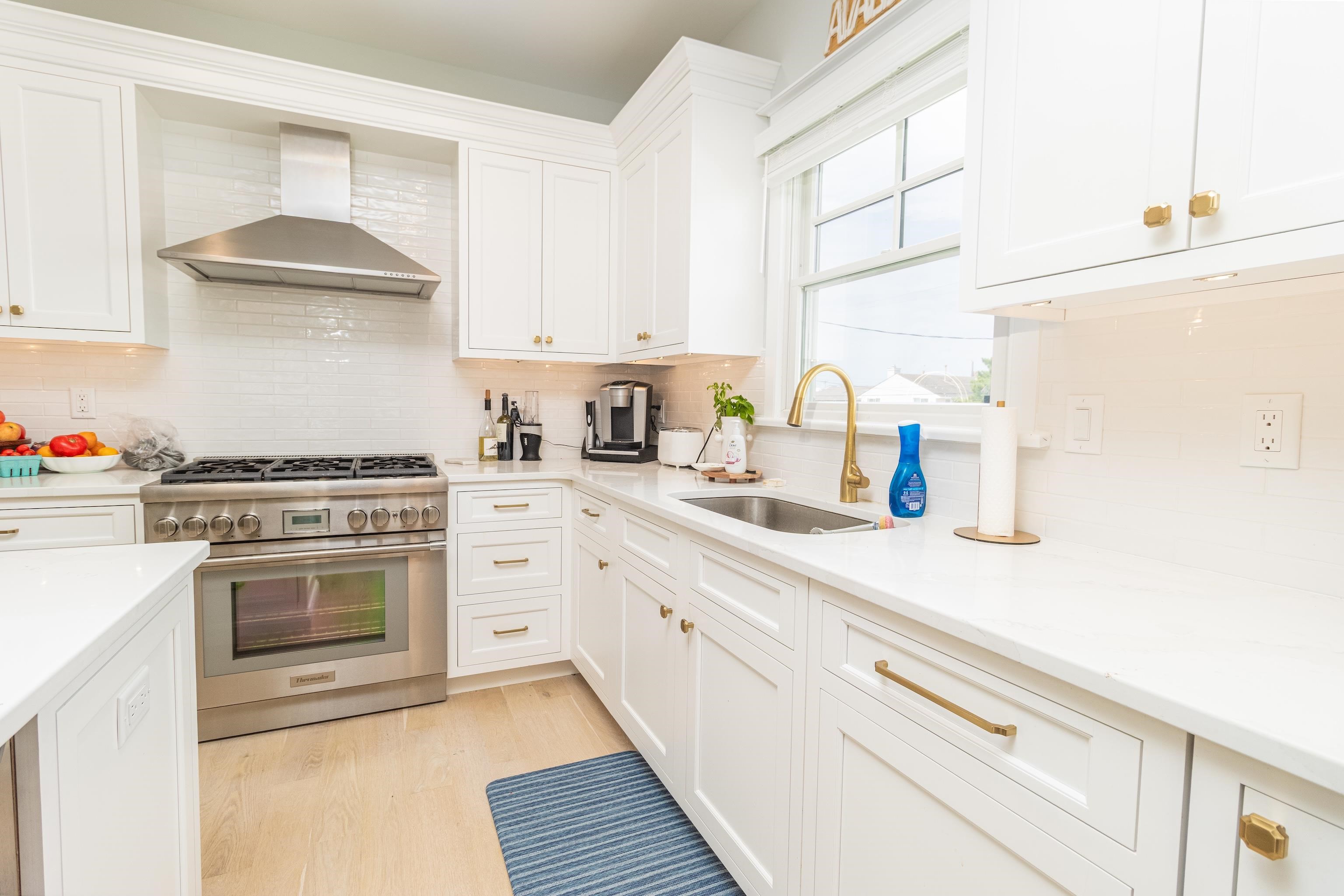 8 East 27th, Unit WEST Avalon, NJ 08202 - Photo 15 of 32 a kitchen with cabinets stainless steel appliances and a counter space