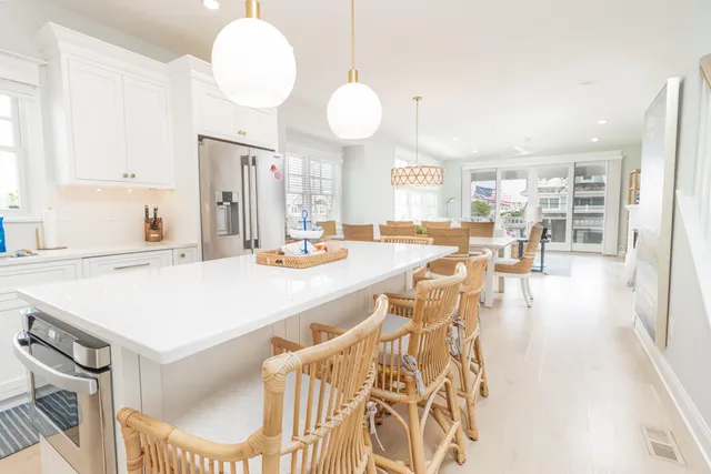 a large kitchen with a table and chairs
