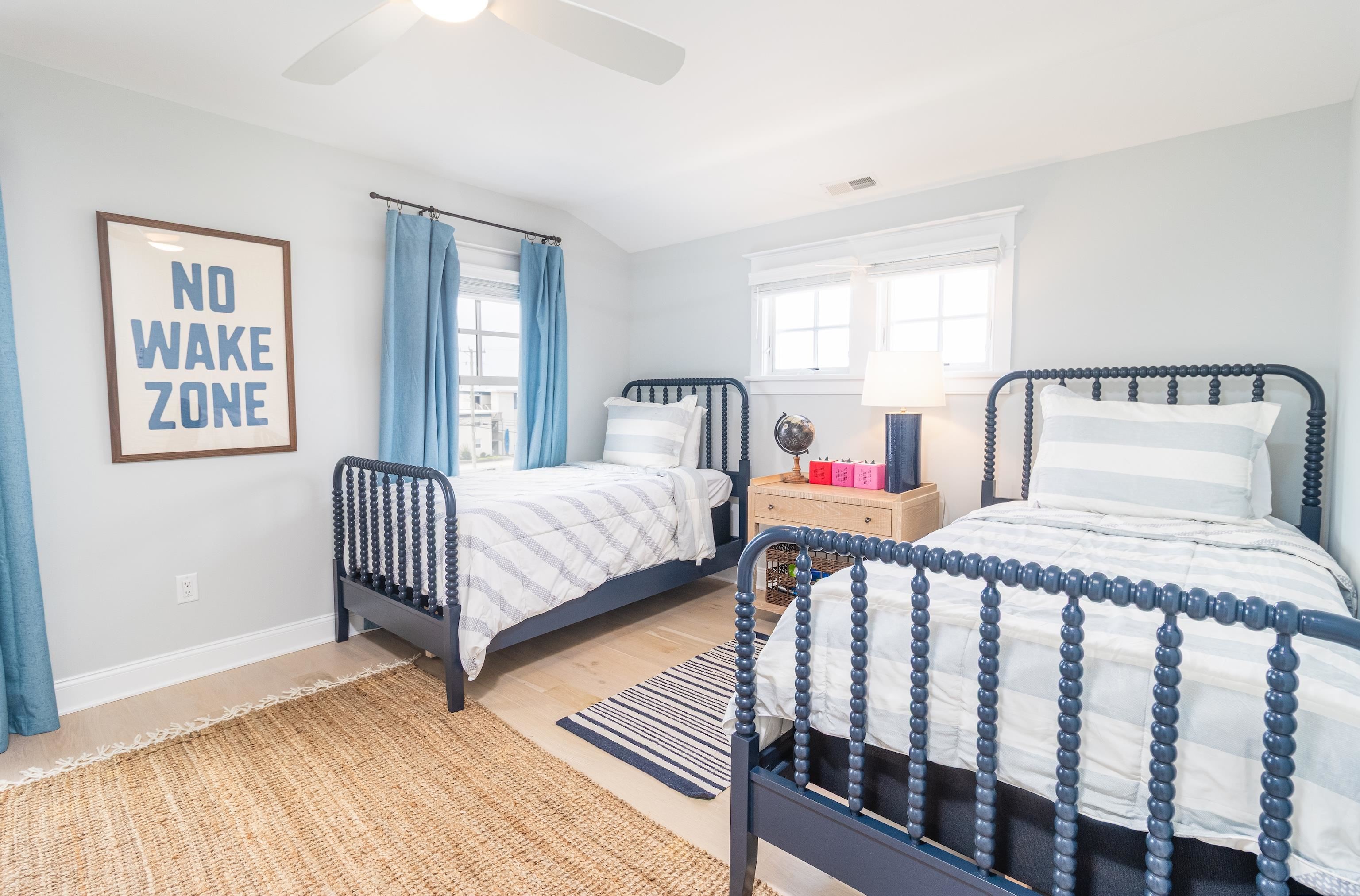 8 East 27th, Unit WEST Avalon, NJ 08202 - Photo 21 of 32 a bedroom with a bed and a night stand