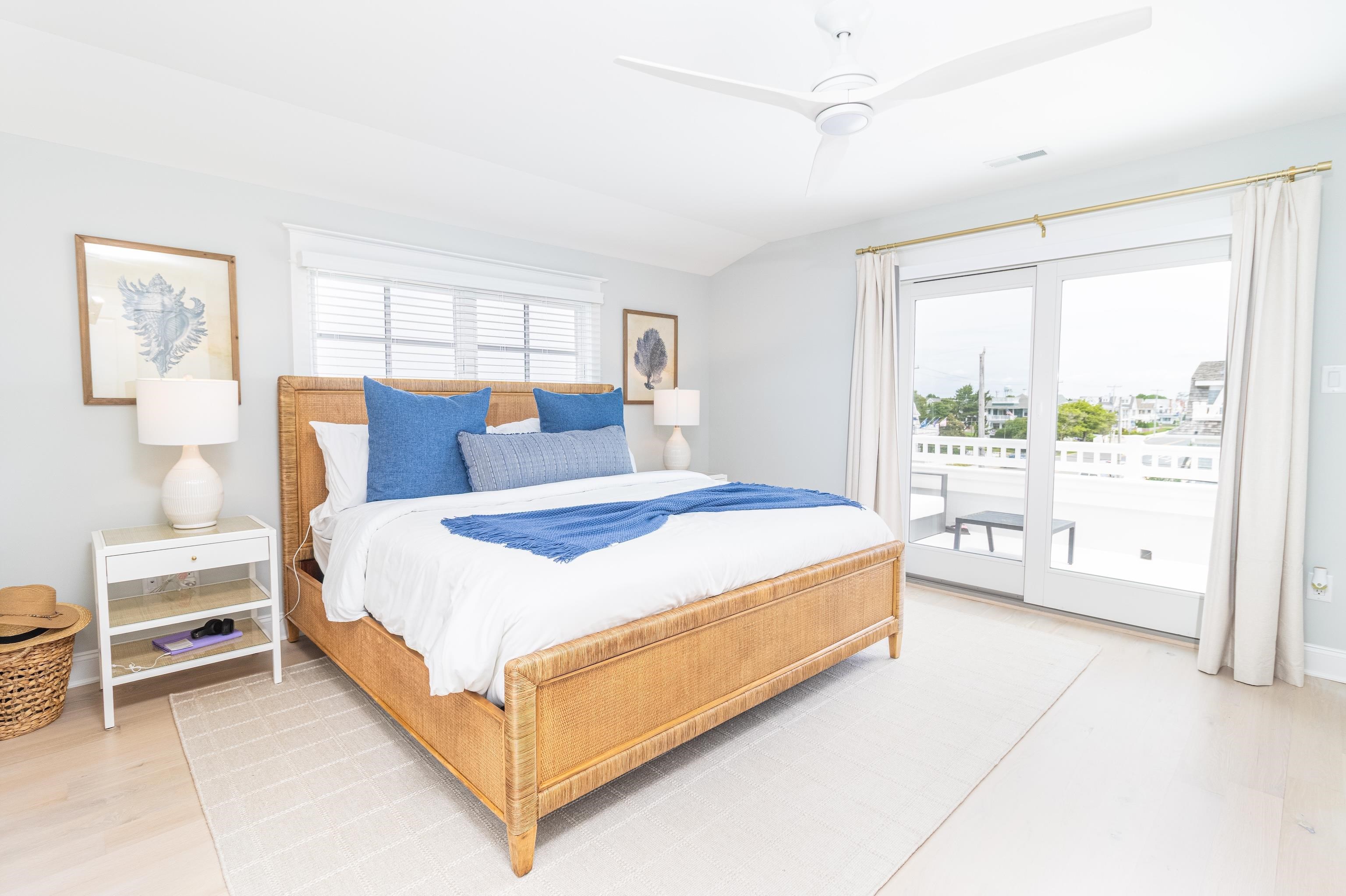 8 East 27th, Unit WEST Avalon, NJ 08202 - Photo 24 of 32 a bedroom with a bed lamp and a large window