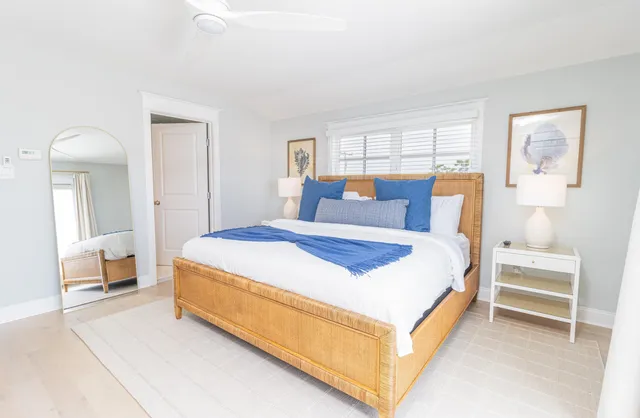 a bedroom with a bed a table and painting