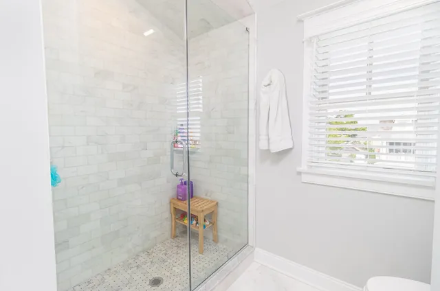 a bathroom with a shower and a sink