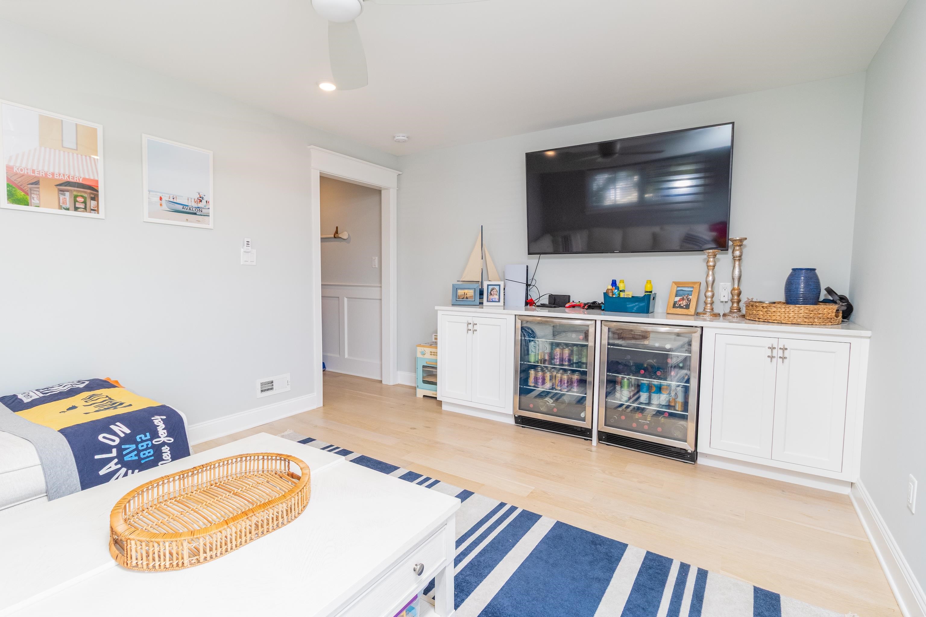 8 East 27th, Unit WEST Avalon, NJ 08202 - Photo 6 of 32 a living room with furniture and a flat screen tv