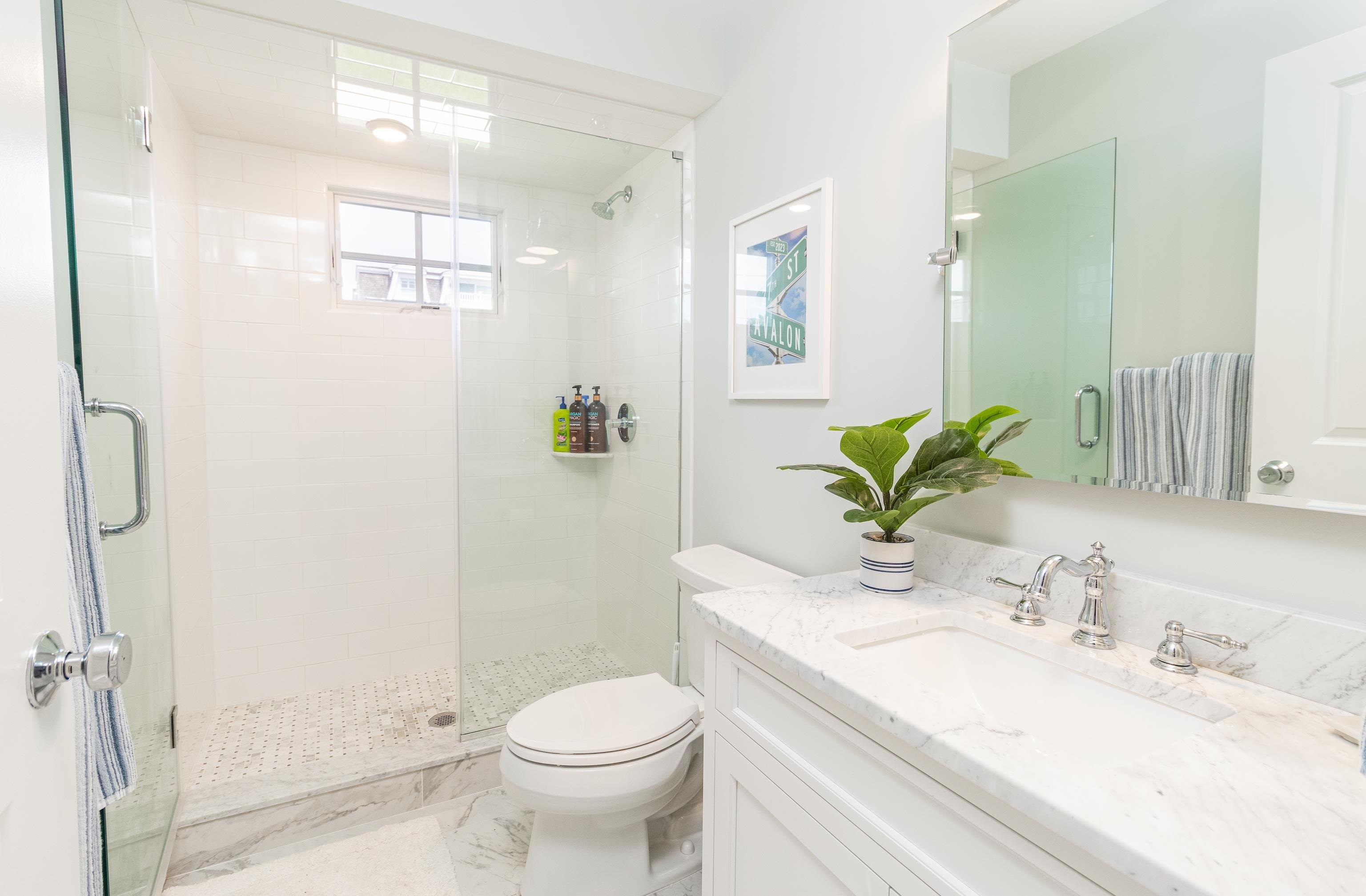 8 East 27th, Unit WEST Avalon, NJ 08202 - Photo 8 of 32 a bathroom with a granite countertop sink a toilet and shower