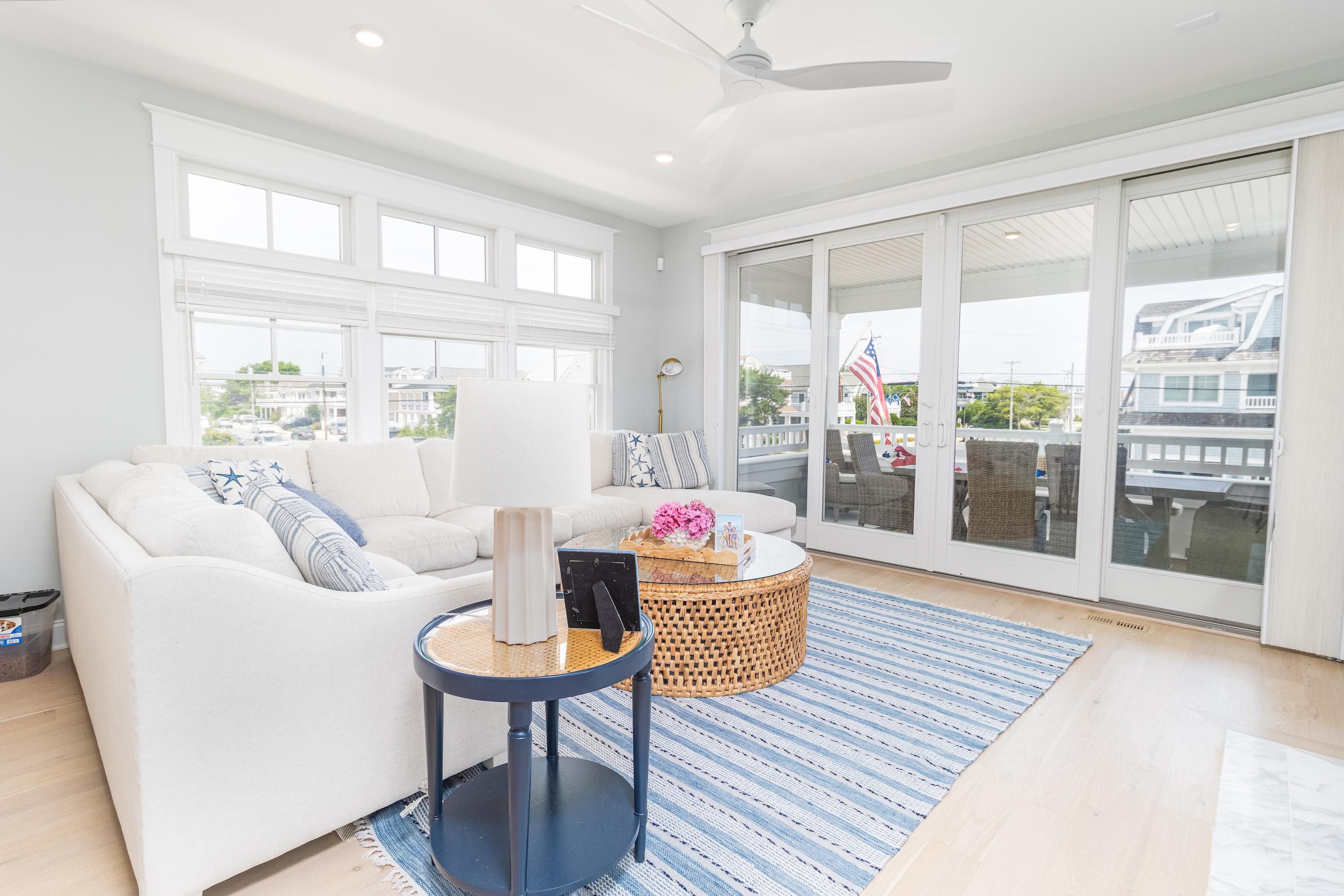 8 East 27th, Unit WEST Avalon, NJ 08202 - Photo 9 of 32 a living room with furniture a large window and wooden floor