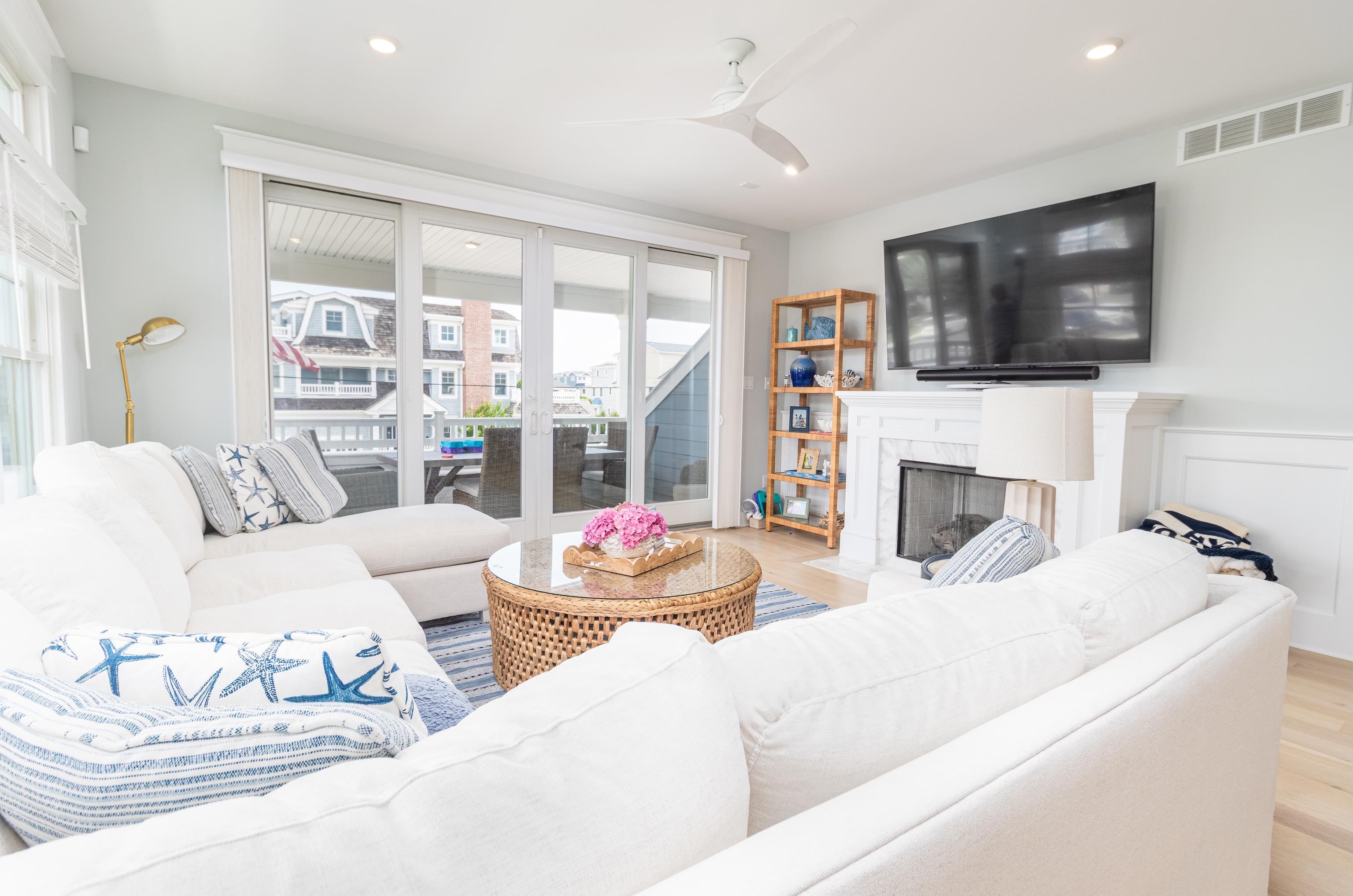 8 East 27th, Unit WEST Avalon, NJ 08202 - Photo 10 of 32 a living room with fireplace furniture and a flat screen tv