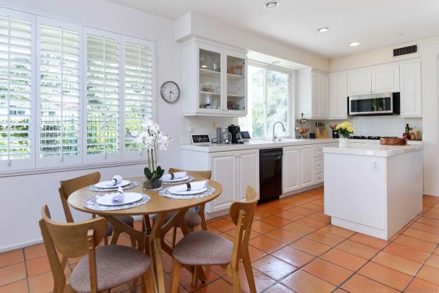 a view of a dining room with furniture and a large window