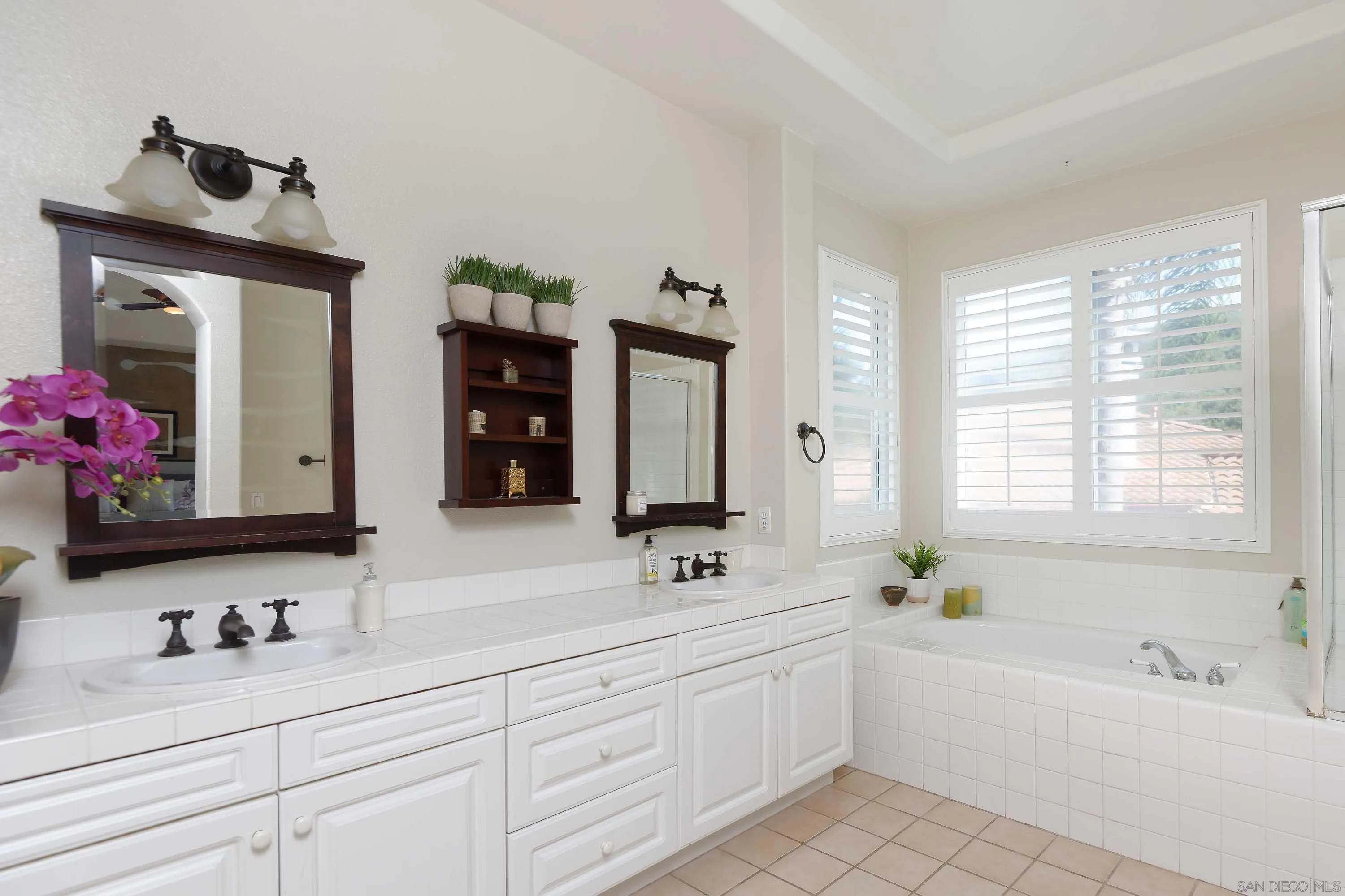 2795 Ridgegate Row La Jolla, CA 92037 - Photo 4 of 4 a bathroom with a sink double vanity granite tub shower and a mirror