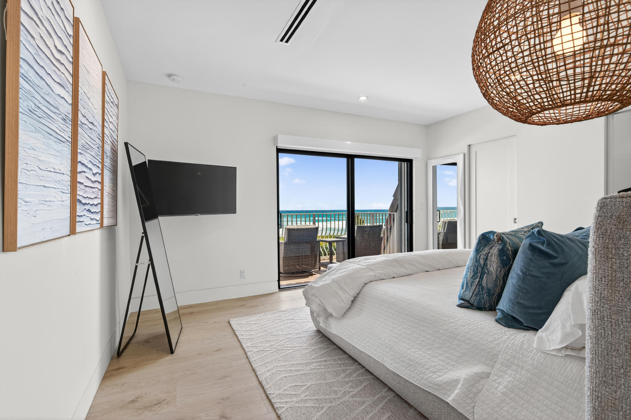 5720 Old Ocean Boulevard, Unit 5E Ocean Ridge, FL 33435 - Photo 15 of 29 a bedroom with a large bed and a flat tv screen