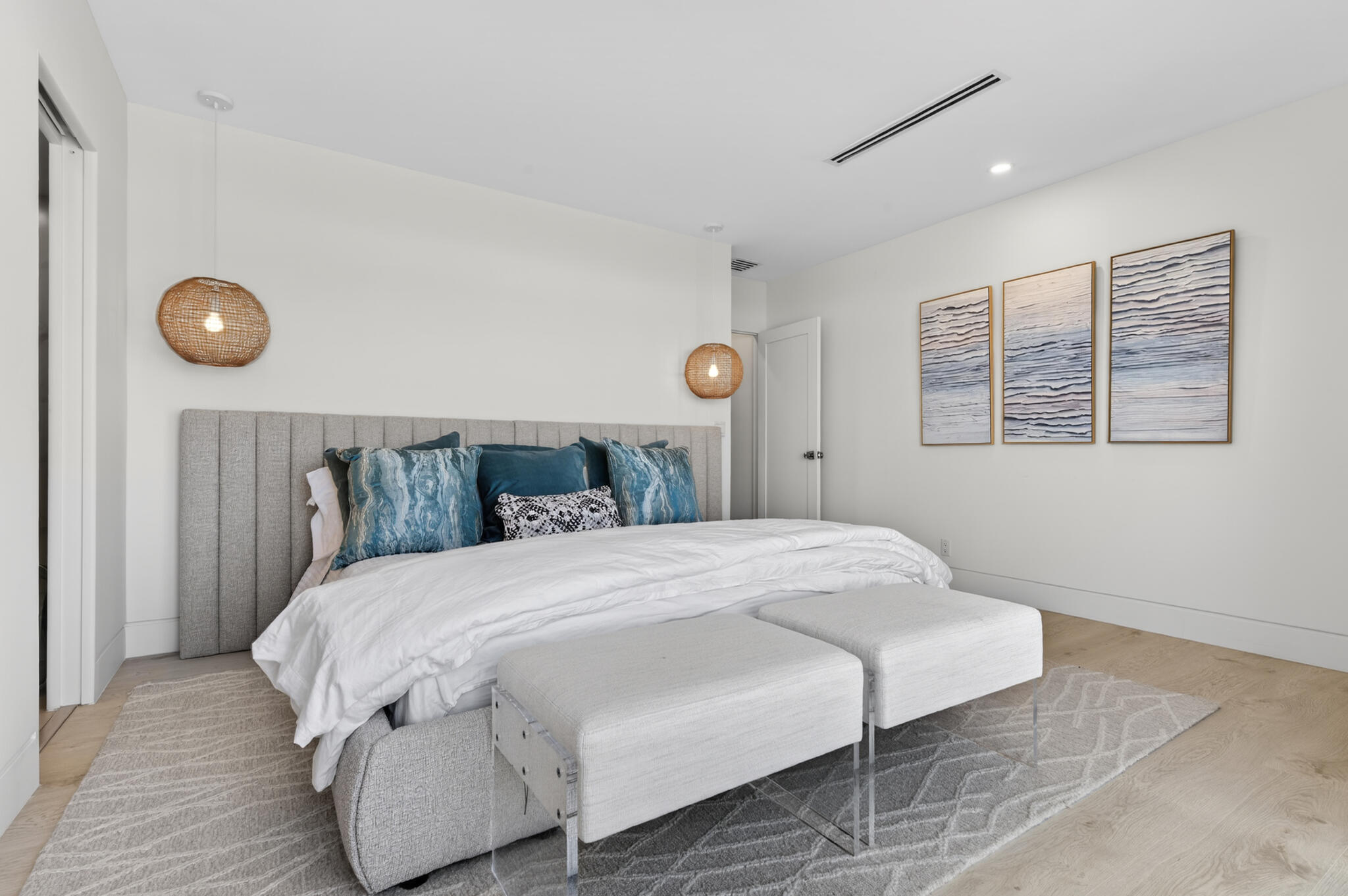 5720 Old Ocean Boulevard, Unit 5E Ocean Ridge, FL 33435 - Photo 17 of 29 a bedroom with a bed and wooden floor