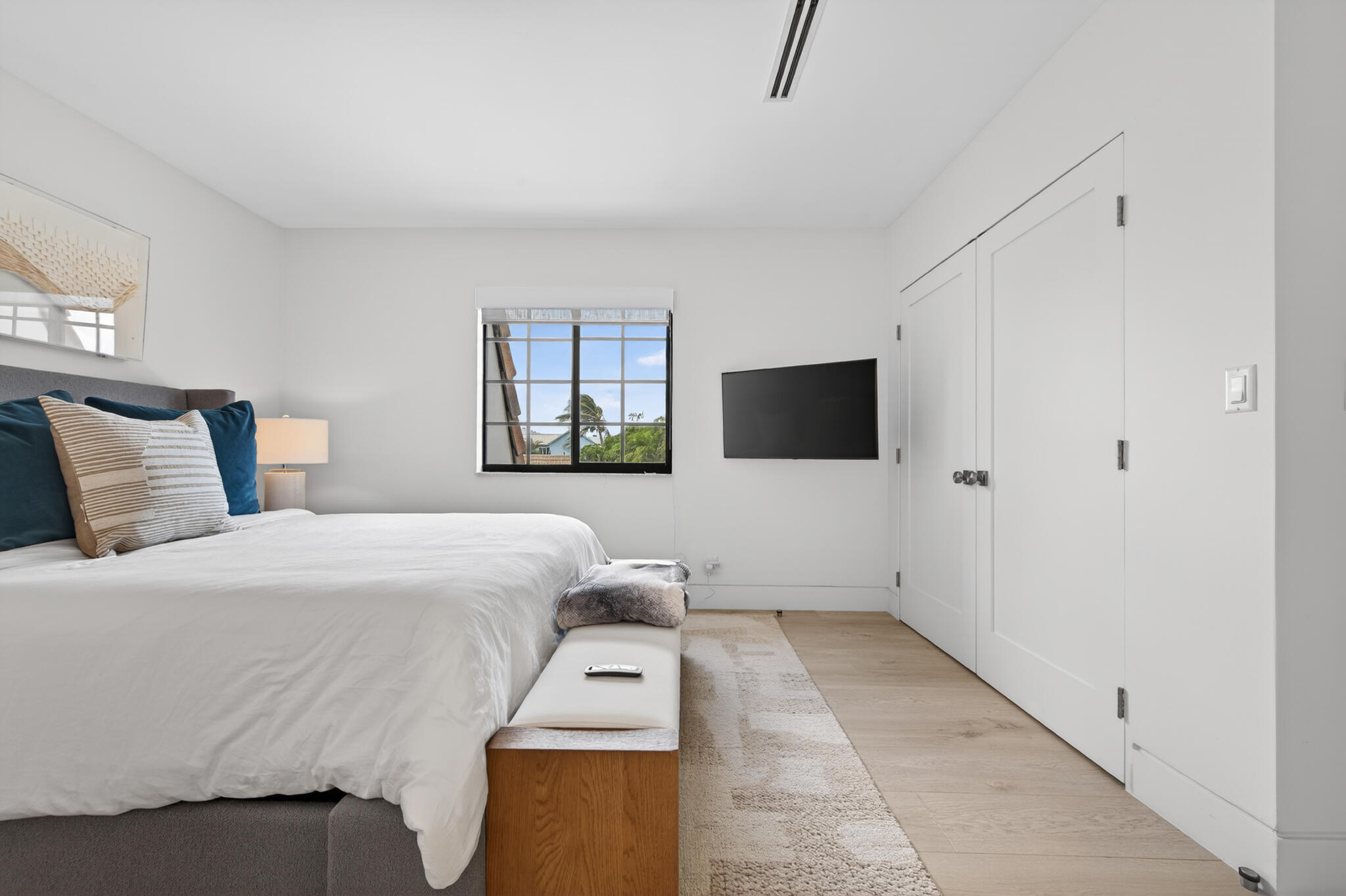 5720 Old Ocean Boulevard, Unit 5E Ocean Ridge, FL 33435 - Photo 22 of 29 a bedroom with a bed and a flat screen tv