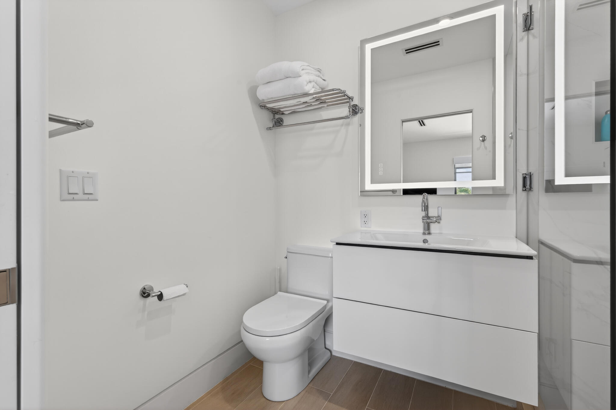 5720 Old Ocean Boulevard, Unit 5E Ocean Ridge, FL 33435 - Photo 24 of 29 a bathroom with a toilet sink and mirror