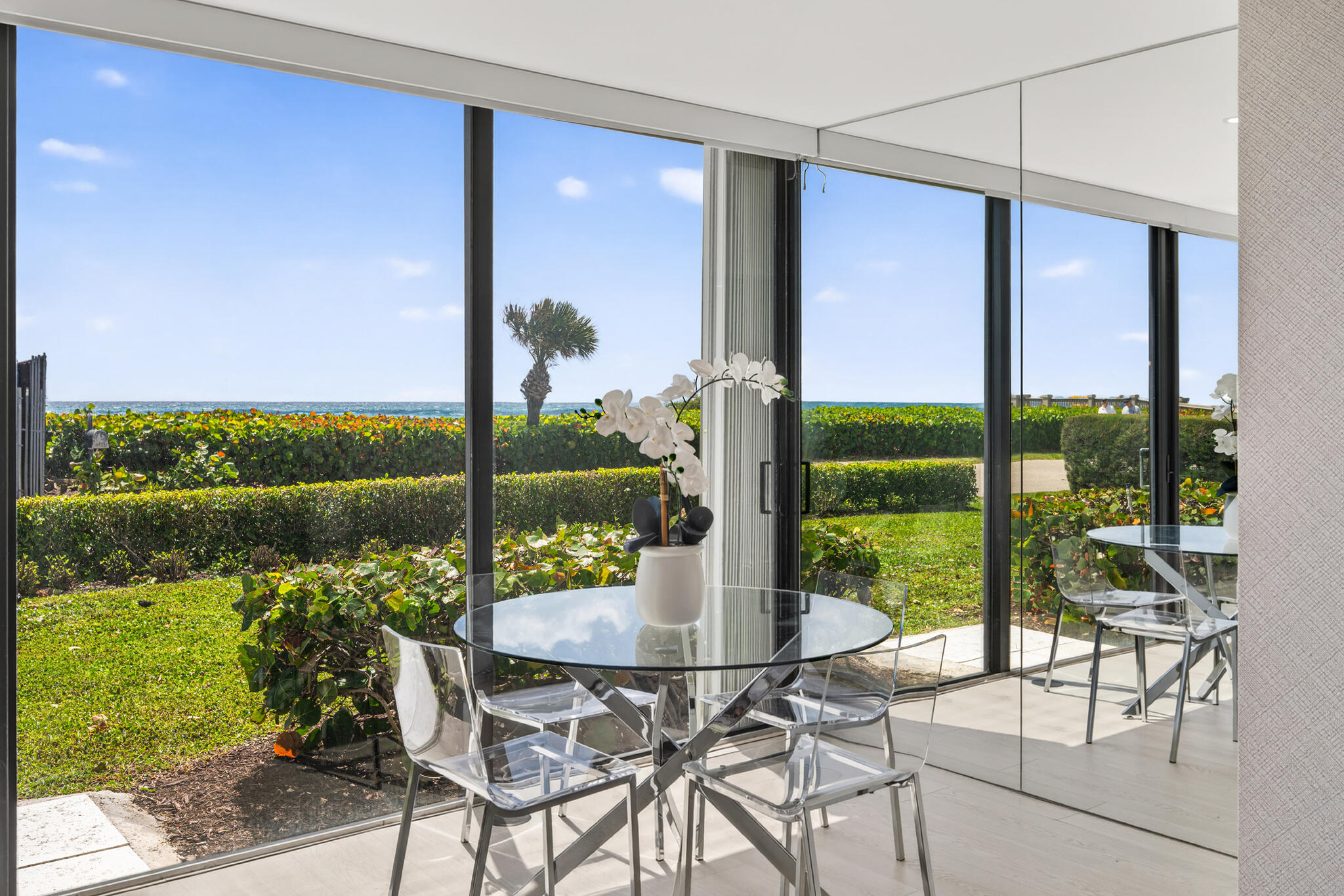 5720 Old Ocean Boulevard, Unit 5E Ocean Ridge, FL 33435 - Photo 6 of 29 a view of an outdoor dining space with a table and chairs