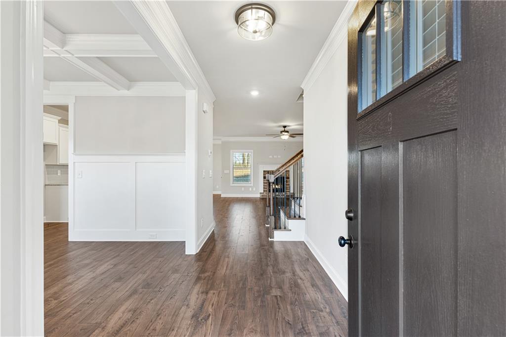 1647 Jasper Drive Winder, GA 30680 - Photo 15 of 16 a view of a hallway with wooden floor and staircase