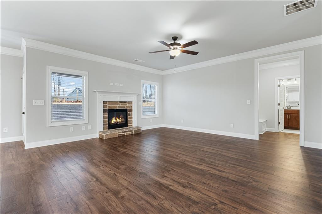 1647 Jasper Drive Winder, GA 30680 - Photo 4 of 16 a view of empty room with wooden floor and fireplace