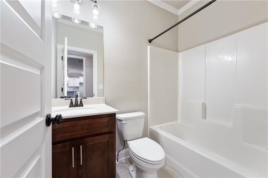 1647 Jasper Drive Winder, GA 30680 - Photo 5 of 16 a bathroom with a sink a toilet and shower