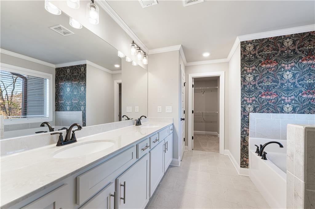 1647 Jasper Drive Winder, GA 30680 - Photo 9 of 16 a spacious bathroom with a double vanity sink mirror and shower