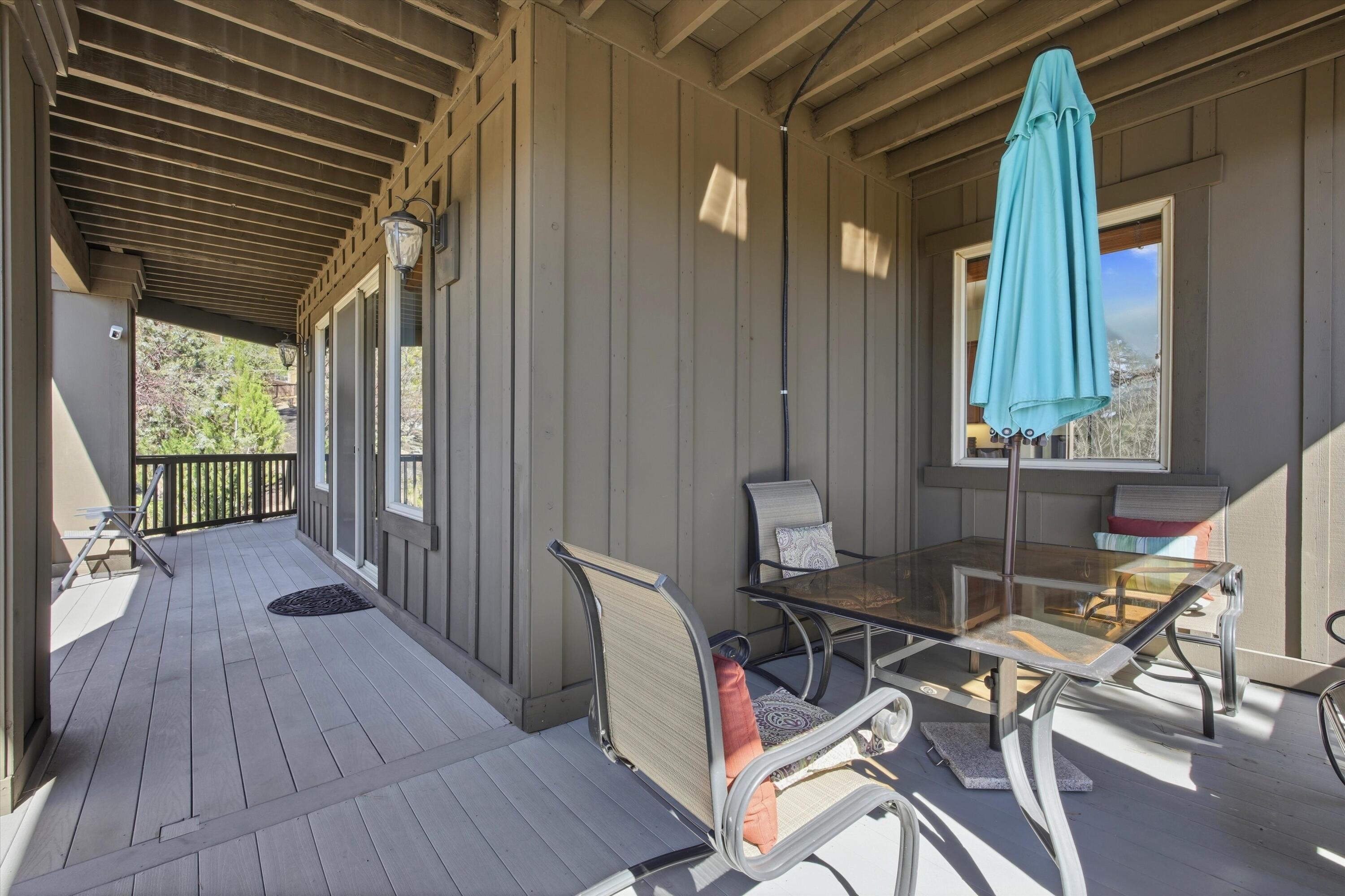 15 Southwest Quail Butte Place Bend, OR 97703 - Photo 47 of 55 a view of a patio with table and chairs and wooden floor