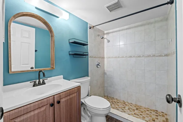 a bathroom with a sink toilet and shower