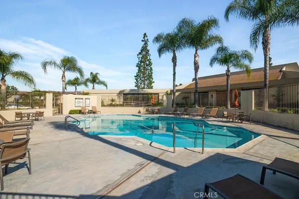 a view of a house with swimming pool and sitting area