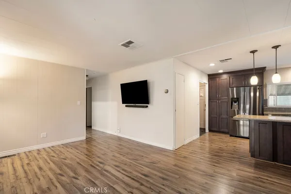 a view of a hardwood floor and windows in a room