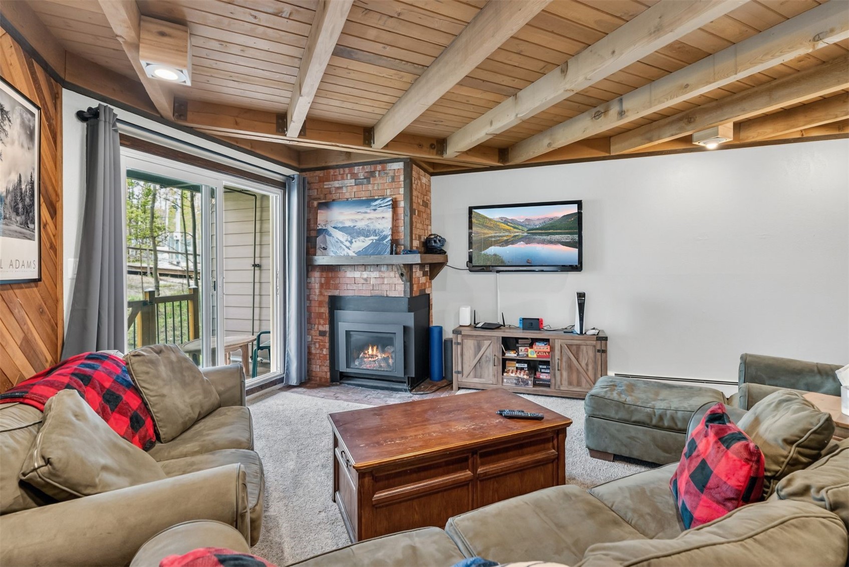 8100 Ryan Gulch Road, Unit 106 Wildernest, CO 80498 - Photo 9 of 43 a living room with furniture a fireplace and a flat screen tv