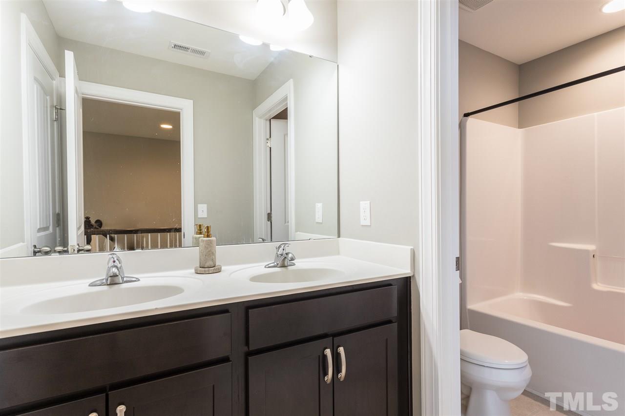 641 Groveview Wynd Wendell, NC 27591 - Photo 23 of 30 Double Sinks and a Tub/Shower Combination. Privacy door between vanity are and tub area.