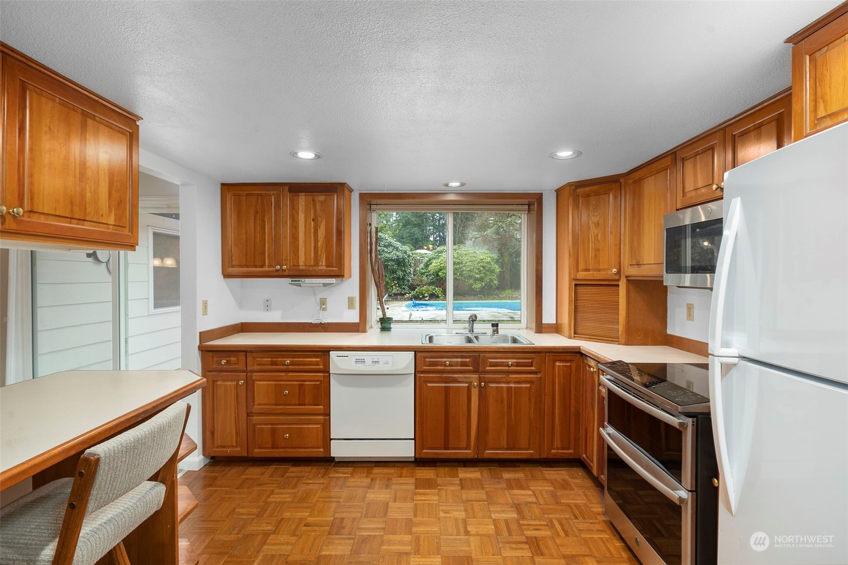 22904 49th Avenue Southeast Bothell, WA 98021 - Photo 10 of 38 a kitchen with stainless steel appliances granite countertop a sink stove and refrigerator