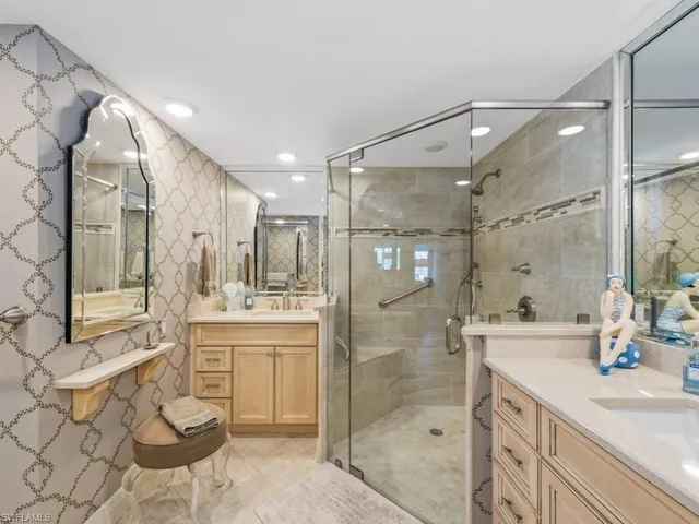 a spacious bathroom with a shower sink mirror and a bathtub