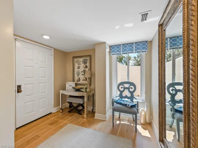 a bedroom with filled window and furniture