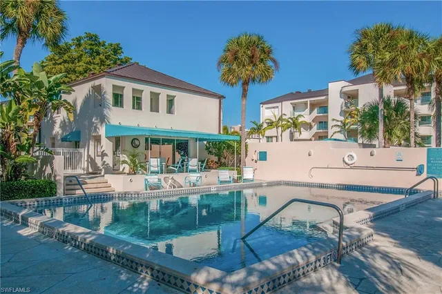 a house view with a seating space and a swimming pool