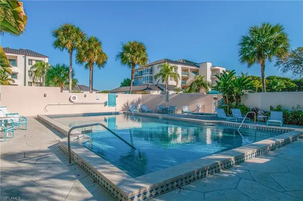 a view of a house with pool and sitting area