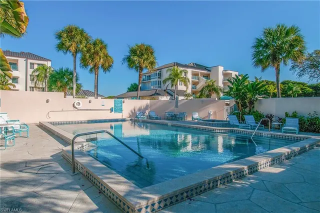 a view of a house with pool and sitting area