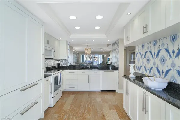 a kitchen with stainless steel appliances granite countertop a sink and cabinets