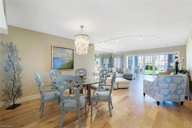 a living room with furniture chandelier and a table