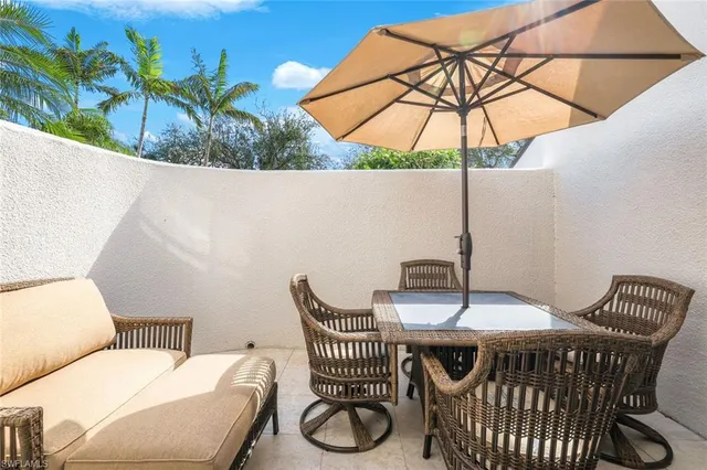 a balcony with table and chairs