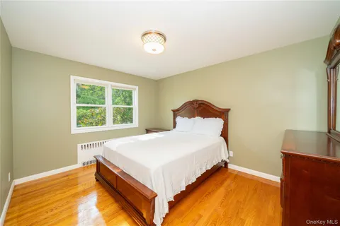 a bed sitting in a bedroom next to a window