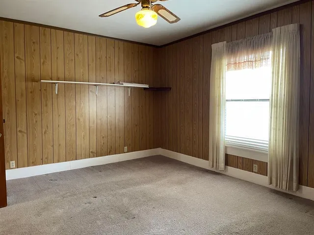 a backyard of a house with lots of green space and fountain