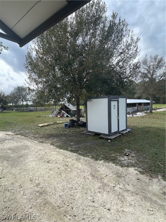 13434 Tangelo Avenue Clewiston, FL 33440 - Photo 23 of 42 a view of a yard with a tree