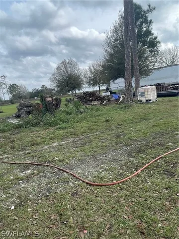 a backyard of a house with barbeque oven table and chairs