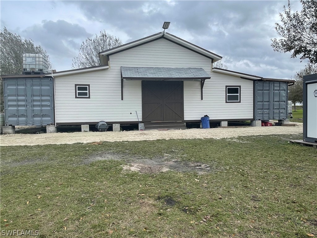 13434 Tangelo Avenue Clewiston, FL 33440 - Photo 3 of 42 a front view of a house with a yard
