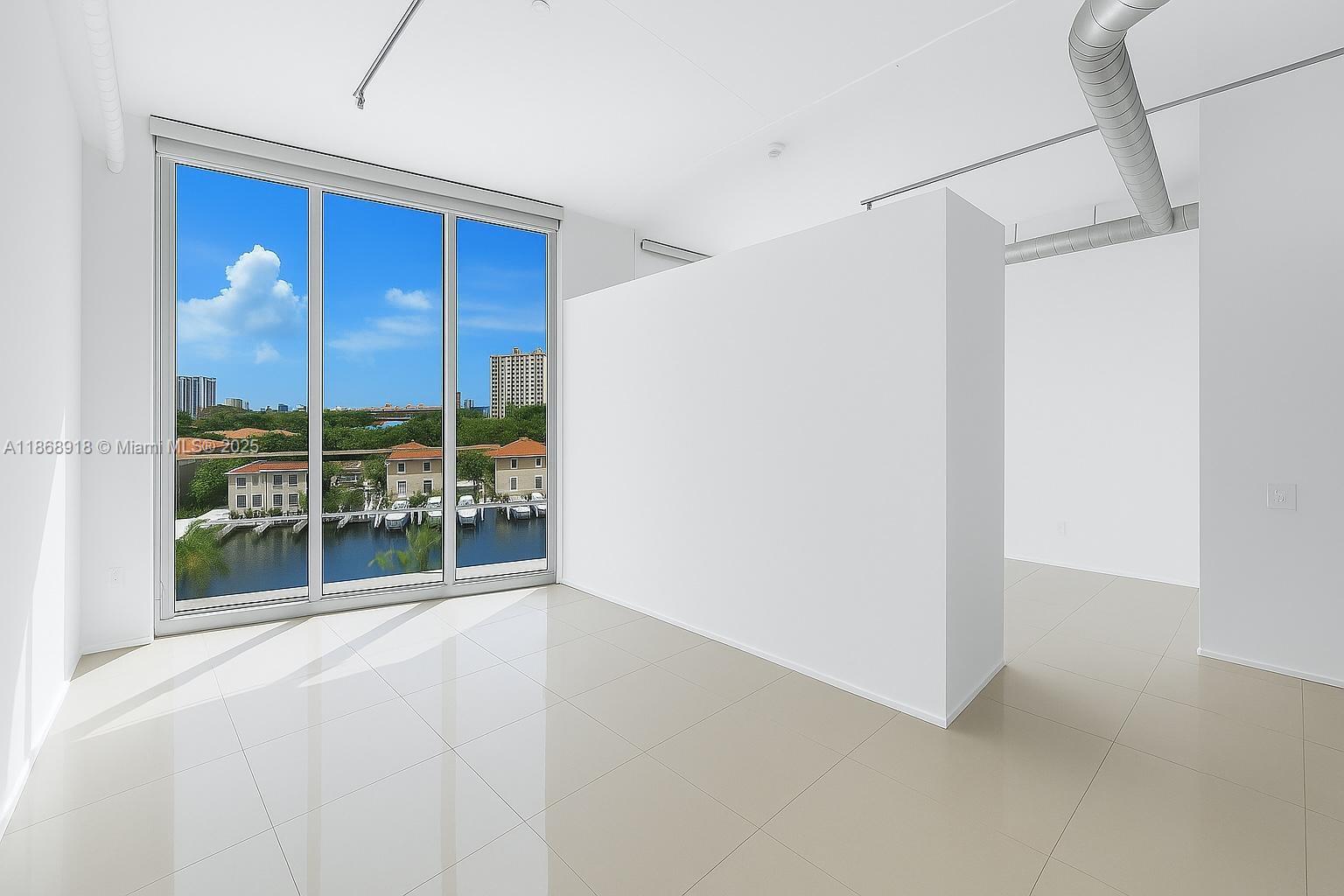 3029 Northeast 188th Street, Unit 924 Aventura, FL 33180 - Photo 1 of 20 a view of an empty room with a window